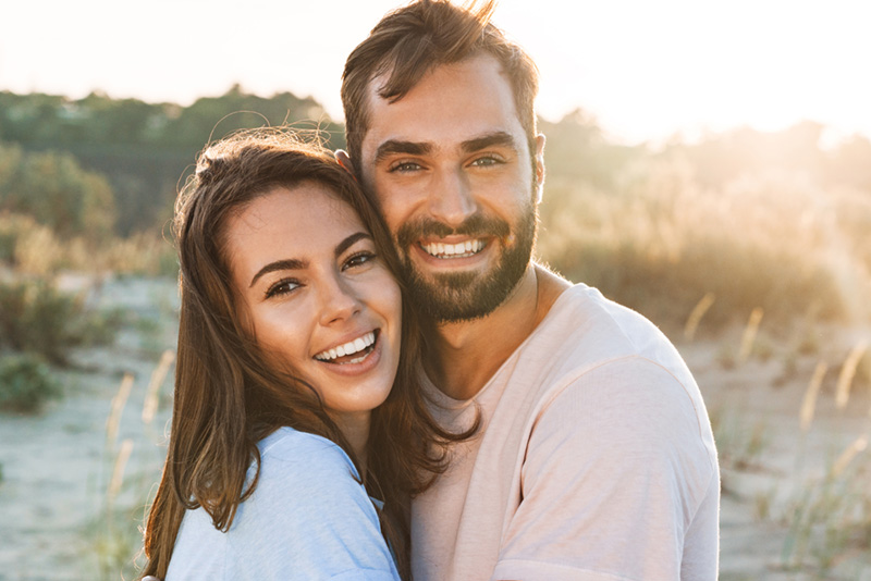 Beautiful young smiling couple spending time at the beach